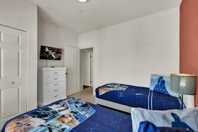 a bedroom with two beds and a dresser at 3206 Gold in Kissimmee