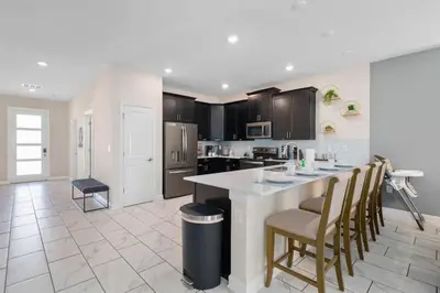 a kitchen with a large island in the middle at Magic Marvel Getaway in Kissimmee