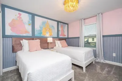 a bedroom with two beds and a chandelier at Charming 4Bd w Private Pool @ Storey Lake Resort 2653 in Kissimmee