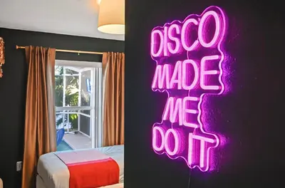 a neon sign that says ego made me do it in a bedroom at Disney World Getaway: 4 Br - Sunroof - BBQ Bliss in Orlando