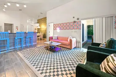 a living room with a couch and a table at Disney World Getaway: 4 Br - Sunroof - BBQ Bliss in Orlando