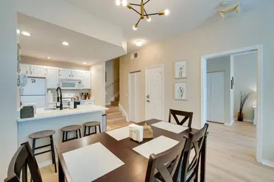 a dining room and kitchen with a table and chairs at Haven Beautiful 3 BR TH in Gated Resort Community in Kissimmee