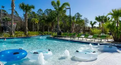 a pool at a resort with water fountains at New Home 5 Bedrooms and 4 Bathrooms At Storey Lake in Kissimmee