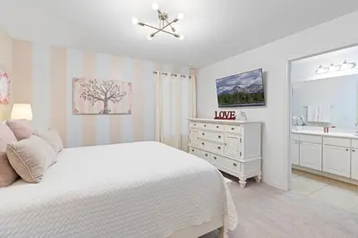 a white bedroom with a bed and a dresser at Amazing 5Bedrooms4.5Baths- Nexto to Disney in Kissimmee