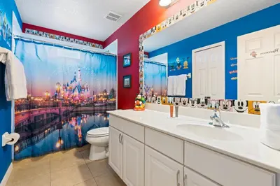 a bathroom with a disneyland mural on the wall at Amazing 5Bedrooms4.5Baths- Nexto to Disney in Kissimmee