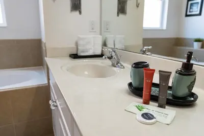 a bathroom counter with a sink and a mirror at Amazing 5Bedrooms4.5Baths- Nexto to Disney in Kissimmee