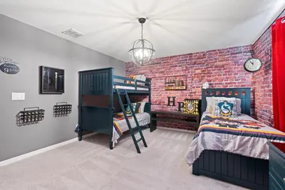 a bedroom with a brick wall and bunk beds at Amazing 5Bedrooms4.5Baths- Nexto to Disney in Kissimmee