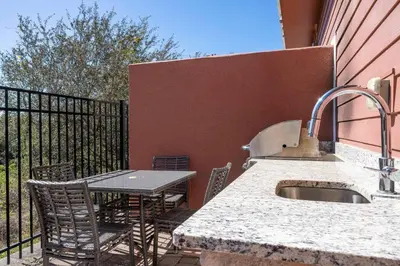 a patio with a sink and a table and chairs at Awesome 4 Suites Villa 5 Min to Disney in Orlando