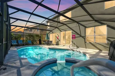 a large swimming pool with a roof at 8462 Secret Key Cove in Kissimmee
