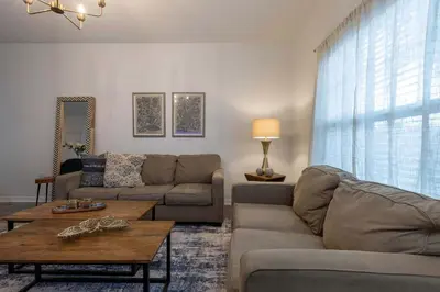 a living room with a couch and a table at Fabulous townhome near the Parks in Kissimmee