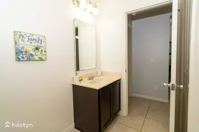 a bathroom with a sink and a mirror at Beautiful vacation home near Disney in Kissimmee