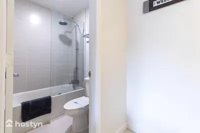 a bathroom with a toilet and a tub and a sink at Amazing hotel room near Disney for 4 people in Kissimmee