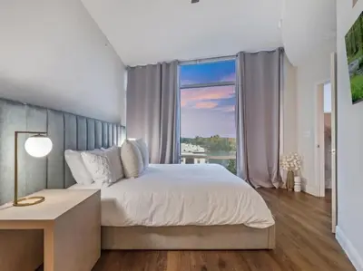 a bedroom with a large bed and a large window at 4Bedroom/ 2bath 2100sq ft Thorton Park Master Suite in Orlando
