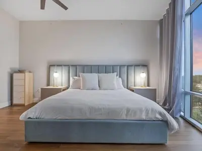a bedroom with a large bed with two lamps at 4Bedroom/ 2bath 2100sq ft Thorton Park Master Suite in Orlando