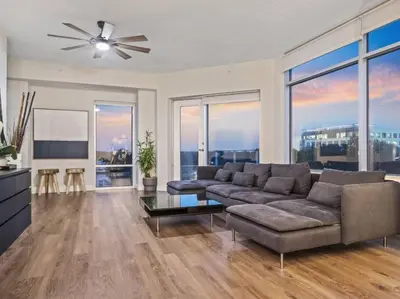 a living room with a couch and a ceiling fan at 4Bedroom/ 2bath 2100sq ft Thorton Park Master Suite in Orlando