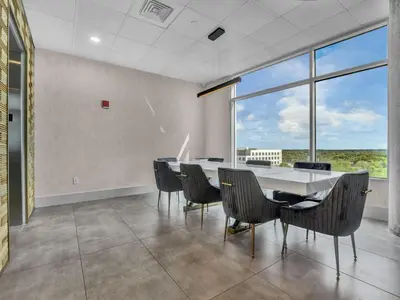 a dining room with a table and chairs and a large window at 4Bedroom/ 2bath 2100sq ft Thorton Park Master Suite in Orlando