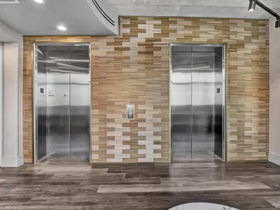 a brick wall with three elevators in a lobby at 4Bedroom/ 2bath 2100sq ft Thorton Park Master Suite in Orlando