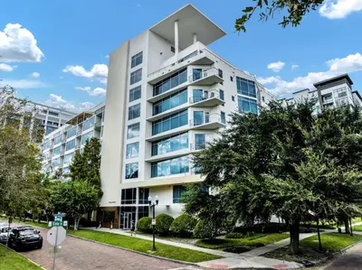 a large white building with trees in front of it at 4Bedroom/ 2bath 2100sq ft Thorton Park Master Suite in Orlando