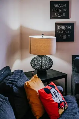 a lamp sitting on a table next to a couch at Family house with amazing themed rooms in Kissimmee