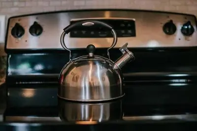 a tea kettle sitting on top of an oven at Family house with amazing themed rooms in Kissimmee