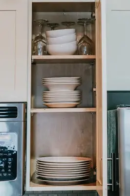 a cabinet filled with plates and dishes in a kitchen at Family house with amazing themed rooms in Kissimmee