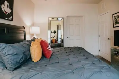 a bedroom with a bed with pillows on it at Family house with amazing themed rooms in Kissimmee