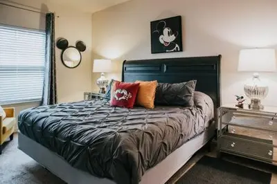 a bedroom with a bed with pillows on it at Family house with amazing themed rooms in Kissimmee