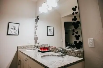 a bathroom with a sink and a mirror at Family house with amazing themed rooms in Kissimmee