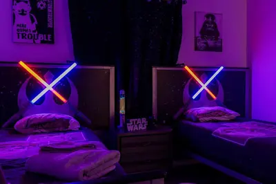 a room with two beds with purple and pink lights at Amazing house near the parks in Kissimmee