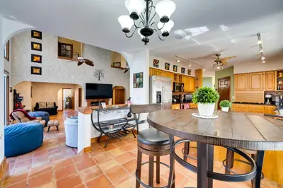 a kitchen and living room with a table and chairs at 1-Acre Backyard and Gym Spacious Apopka Escape! in Orlando