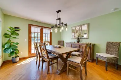 a dining room with a wooden table and chairs at 1-Acre Backyard and Gym Spacious Apopka Escape! in Orlando