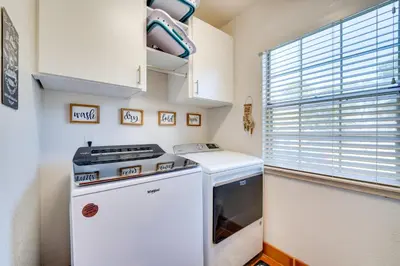 a small kitchen with a stove and a window at 1-Acre Backyard and Gym Spacious Apopka Escape! in Orlando