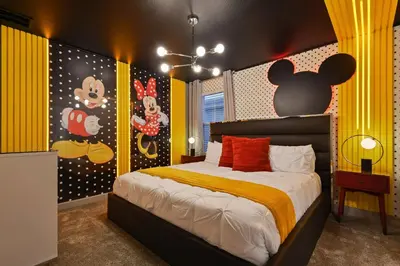 a bedroom with a bed with a mickey mouse mural at 5 Star Exceptional Luxury Villa at Storey Lake mins to Disney in Kissimmee
