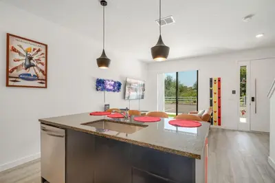 a kitchen with a large island with red counter tops at 3MI from Disney- Modern 3BD 3BA + Grill in Kissimmee