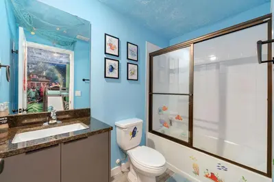 a bathroom with a toilet and a shower and a sink at 3MI from Disney- Modern 3BD 3BA + Grill in Kissimmee