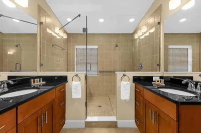 a bathroom with two sinks and a shower at Summer Stay - Renovated TownHome by Disney! in Orlando