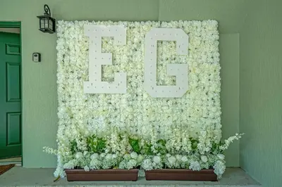 a wall covered in white flowers with the letter e at Summer Stay - Renovated TownHome by Disney! in Orlando