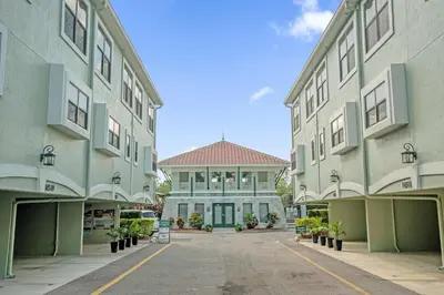 an empty parking lot in front of two buildings at Summer Stay - Renovated TownHome by Disney! in Orlando
