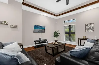 a living room with a couch and a table at Summer Stay - Renovated TownHome by Disney! in Orlando