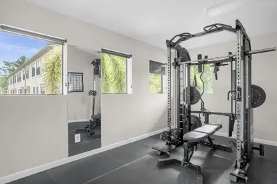 a gym with two tread machines and a mirror at Cozy & Elegant 4BR Enchanted Townhouse - 1 Mile to Disney with Resort Pool, Gym, & Jacuzzi in Orlando