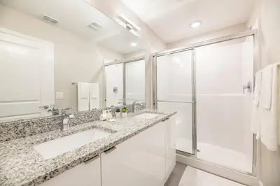 a bathroom with two sinks and a shower at 8005 Stunning Villa Disney Park Proximity in Orlando