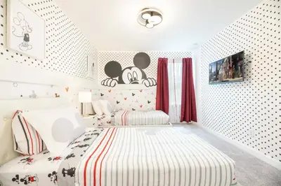 a childs bedroom with a bed and red curtains at 8005 Stunning Villa Disney Park Proximity in Orlando