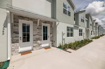 a row of apartment buildings with white doors at 8005 Stunning Villa Disney Park Proximity in Orlando