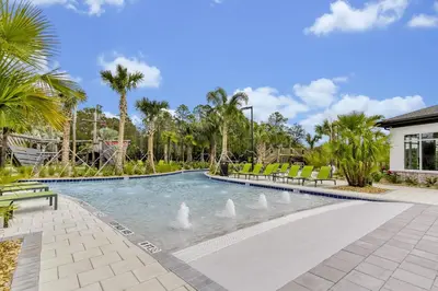 a swimming pool with white swans in the water at Storey Lake Escape w/ Pool, Games & Water Park in Kissimmee