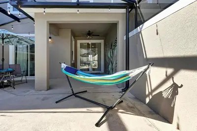 a hammock sitting outside of a house at Storey Lake Escape w/ Pool, Games & Water Park in Kissimmee