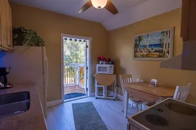 a kitchen with a table and a dining room at Paradise in a country setting 1100 sq ft apartment in Lake Mary