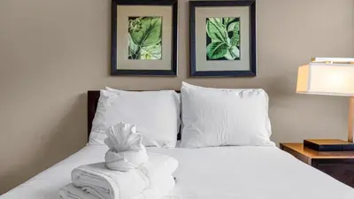 a bedroom with a bed with a towel on it at Florida Getaway - Renovated TownHome by Disney! in Orlando