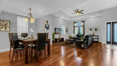 a dining room and living room with a dining table at Florida Getaway - Renovated TownHome by Disney! in Orlando