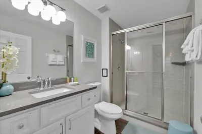 a bathroom with a toilet and a glass shower at 7752 Tosteth in Kissimmee