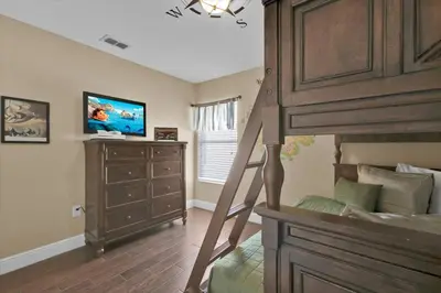 a bedroom with a bunk bed and a television at 7752 Tosteth in Kissimmee